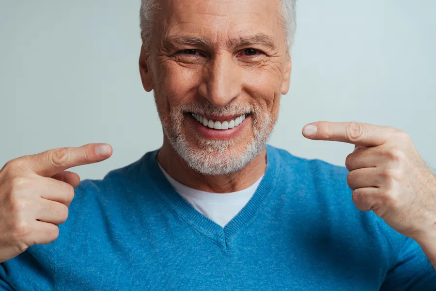 Smiling patient showing off his restored teeth